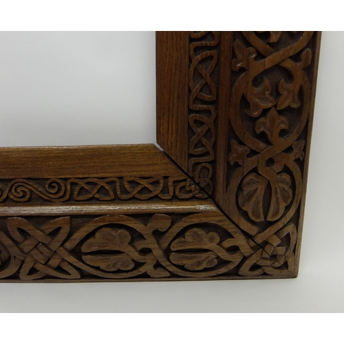 702 - Manner of ALEXANDER RITCHIE an elaborately carved oak picture frame