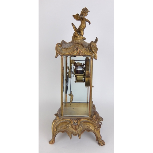 710 - A French Rococo style gilt metal mounted mantle clock