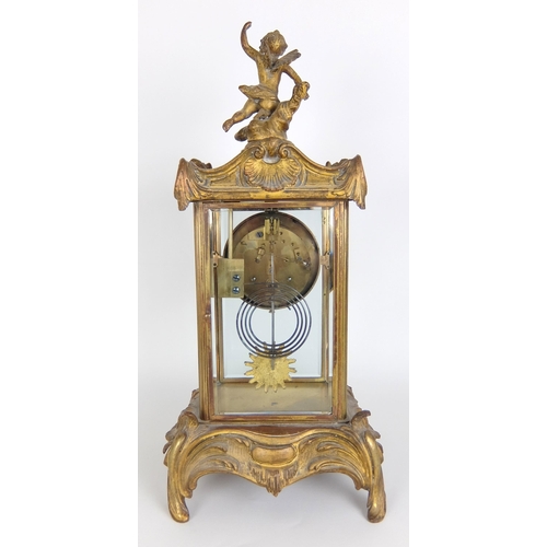 710 - A French Rococo style gilt metal mounted mantle clock