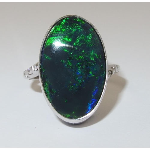 76 - An 18ct white gold ring set with a solid black opal