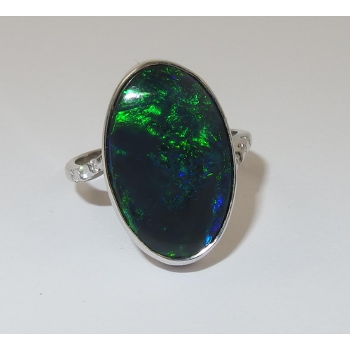 76 - An 18ct white gold ring set with a solid black opal