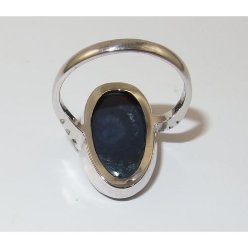 76 - An 18ct white gold ring set with a solid black opal