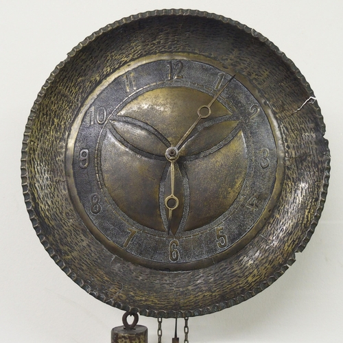 873 - An Arts and Crafts hammered brass 'Wag at the Wa' wall clock