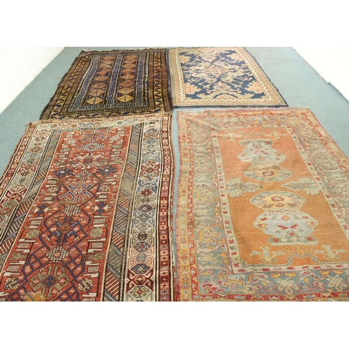 875 - A collection of four assorted Persian floor rugs