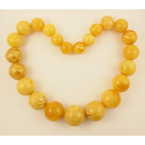 99 - Item 4. A very large royal amber coloured necklace