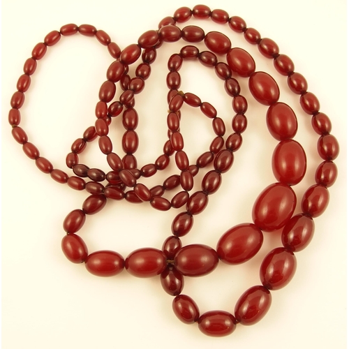 136A - Two strings of cherry amber coloured beads