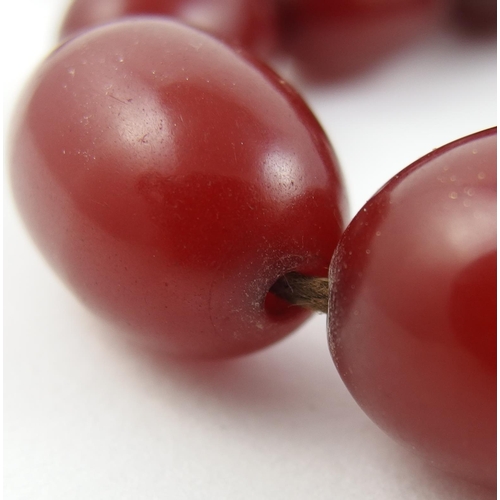 136A - Two strings of cherry amber coloured beads