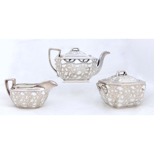 163 - A three piece silver overlaid porcelain tea service