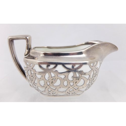 163 - A three piece silver overlaid porcelain tea service