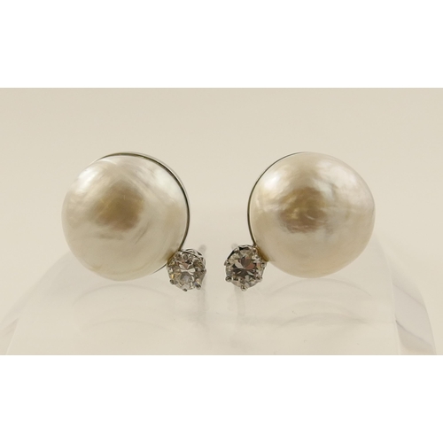 26 - A pair of substantial mabe pearl and diamond earrings