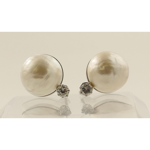 26 - A pair of substantial mabe pearl and diamond earrings