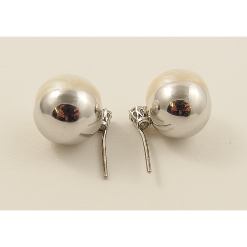 26 - A pair of substantial mabe pearl and diamond earrings