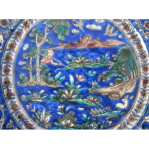 542C - A Persian moulded and painted blue ground circular dish