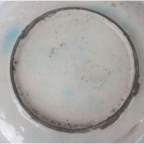 542C - A Persian moulded and painted blue ground circular dish