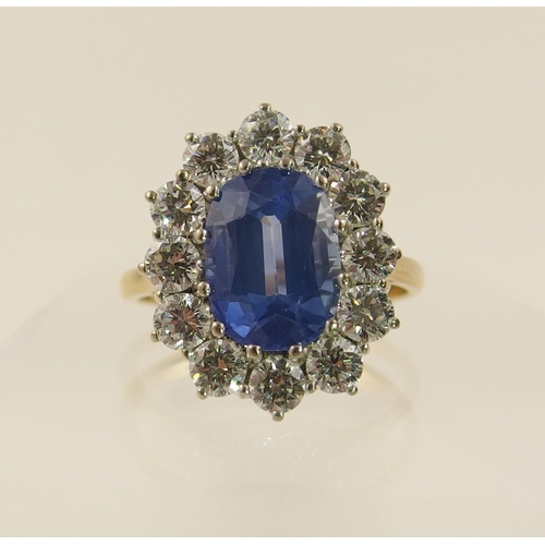 63 - A cornflower blue sapphire and diamond cluster ring