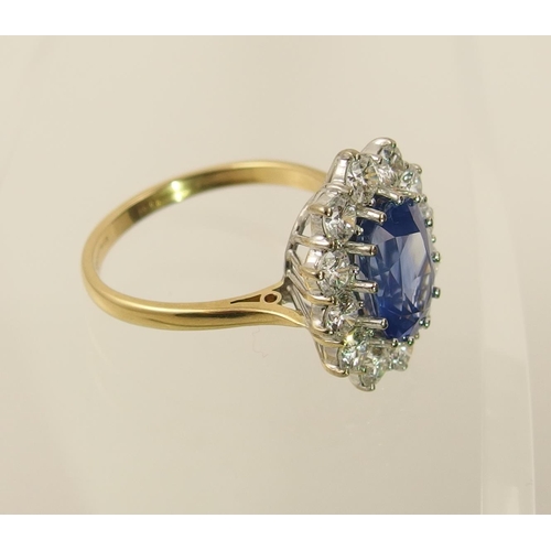 63 - A cornflower blue sapphire and diamond cluster ring