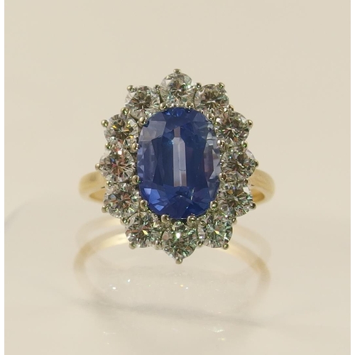 63 - A cornflower blue sapphire and diamond cluster ring