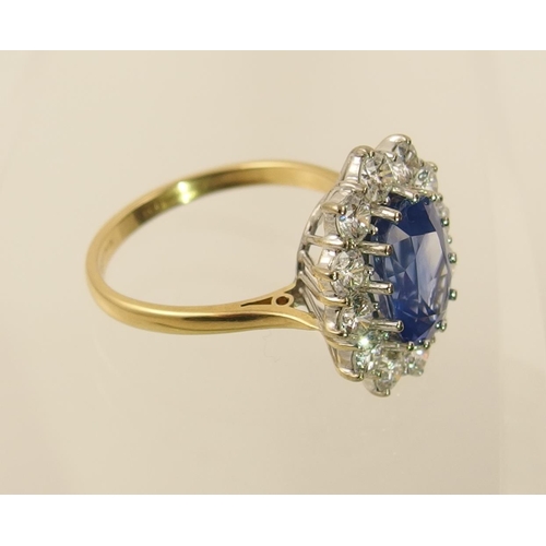 63 - A cornflower blue sapphire and diamond cluster ring