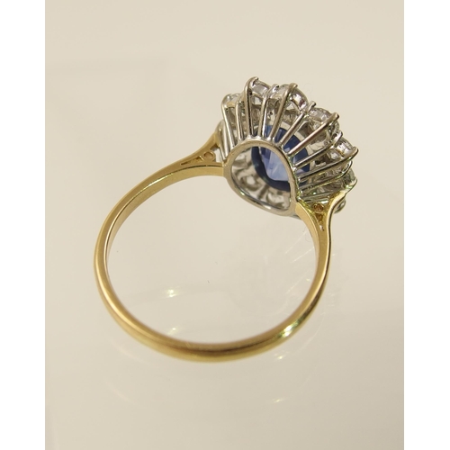 63 - A cornflower blue sapphire and diamond cluster ring