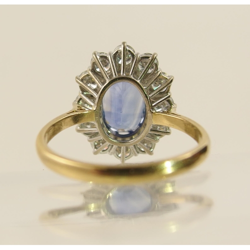 63 - A cornflower blue sapphire and diamond cluster ring