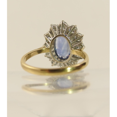 63 - A cornflower blue sapphire and diamond cluster ring