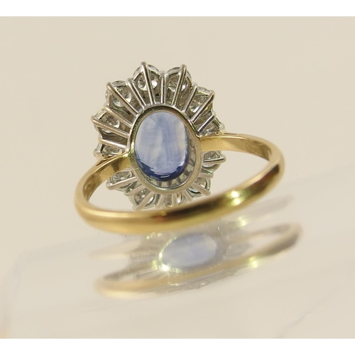 63 - A cornflower blue sapphire and diamond cluster ring