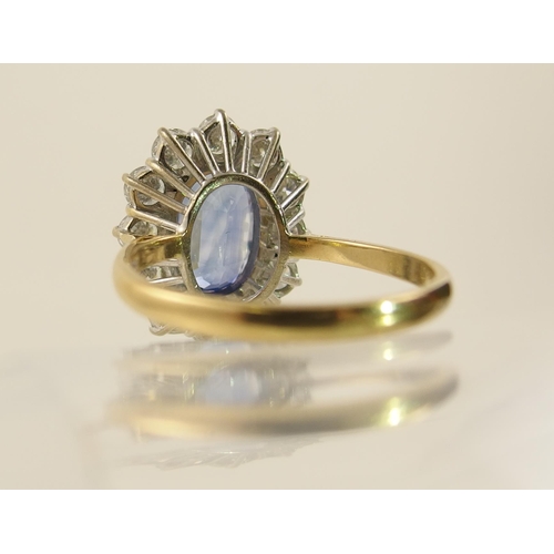 63 - A cornflower blue sapphire and diamond cluster ring