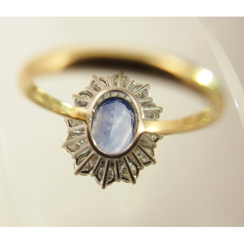 63 - A cornflower blue sapphire and diamond cluster ring