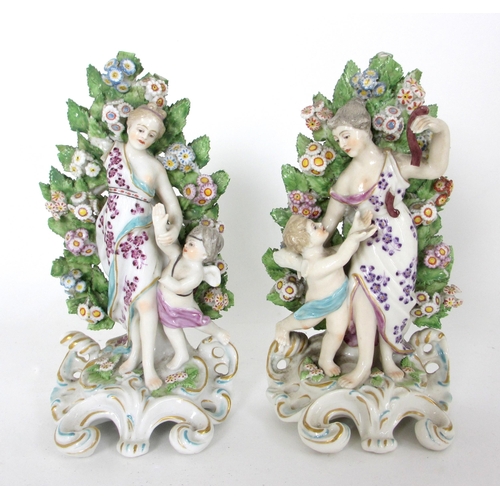 654 - A pair of Derby rococo moulded candlesticks