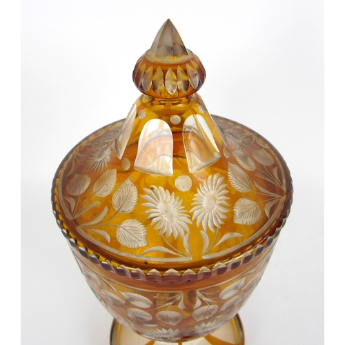 671 - A Bohemian amber flash and cut glass vase and cover