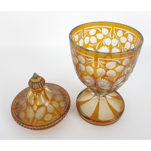 671 - A Bohemian amber flash and cut glass vase and cover