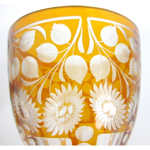 671 - A Bohemian amber flash and cut glass vase and cover