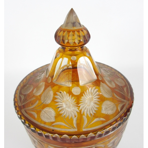 671 - A Bohemian amber flash and cut glass vase and cover