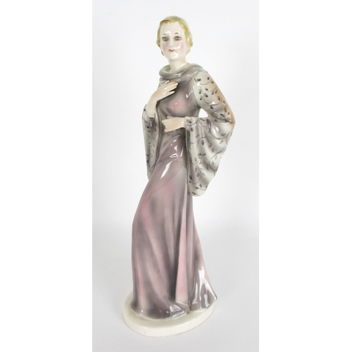 672 - A Continental pottery Art Deco figure of a lady