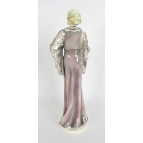 672 - A Continental pottery Art Deco figure of a lady