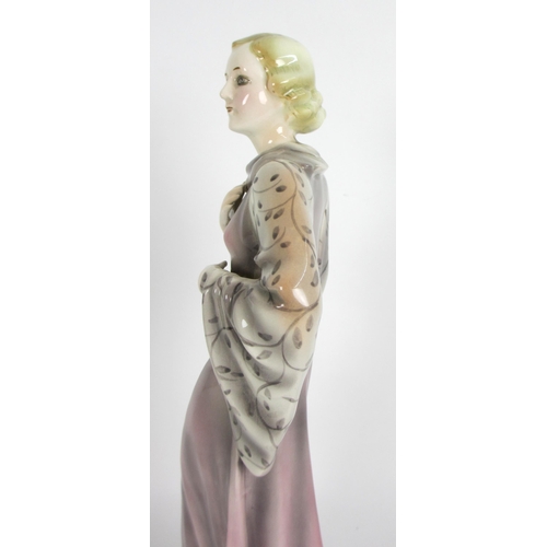 672 - A Continental pottery Art Deco figure of a lady