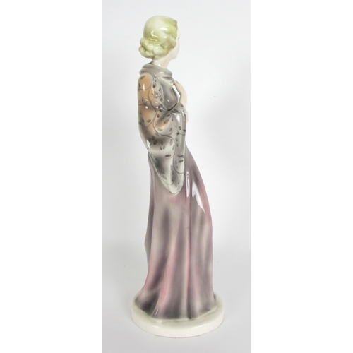 672 - A Continental pottery Art Deco figure of a lady