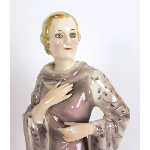 672 - A Continental pottery Art Deco figure of a lady