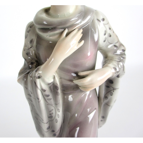 672 - A Continental pottery Art Deco figure of a lady