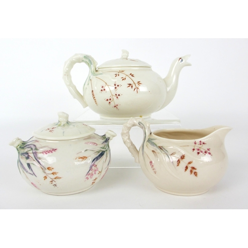 672B - A Belleek teapot  sugar bowl  cover and cream jug