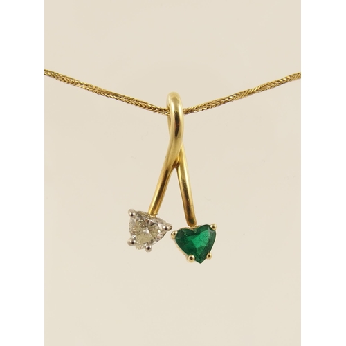 69 - A double heart shaped emerald and diamond pendant