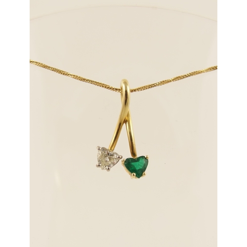 69 - A double heart shaped emerald and diamond pendant