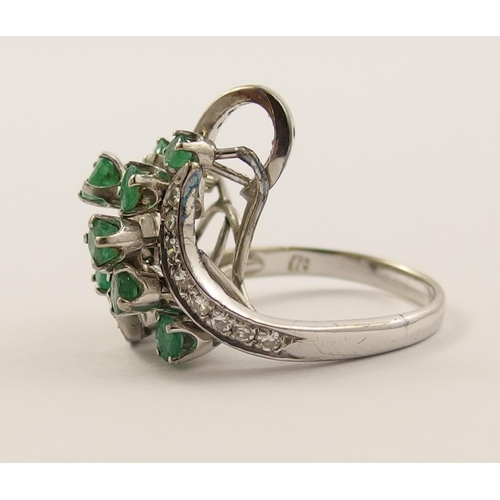 18 - An emerald and diamond cluster ring