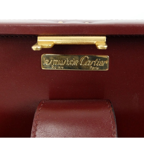 711 - A Cartier burgundy leather and suede briefcase