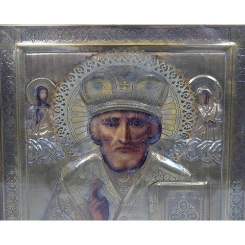 715 - A Russian embossed copper and painted icon of Saint Nicholas