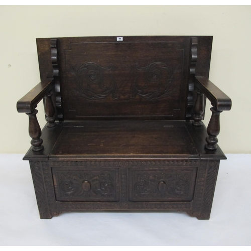 798 - A carved oak Monks bench