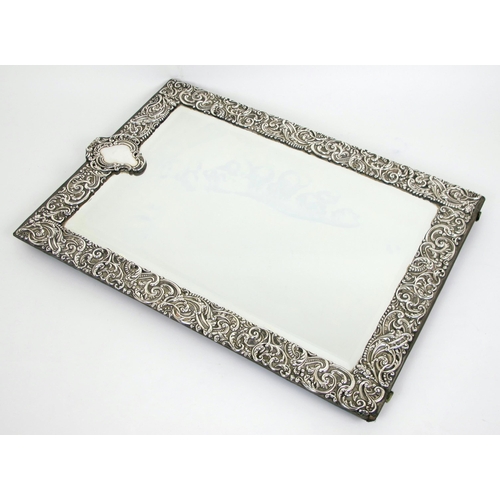 213 - An Edwardian silver mounted easel mirror by Charles Henry Dumenil  London 1909