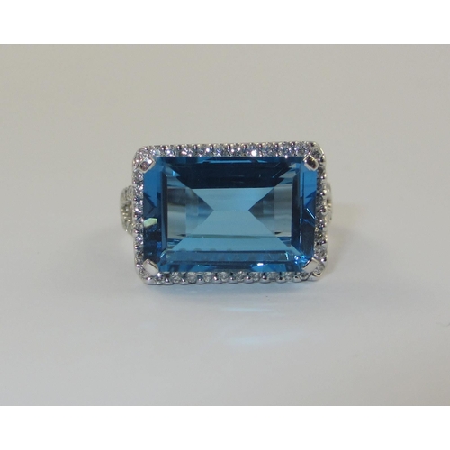 75 - A blue topaz and diamond dress ring