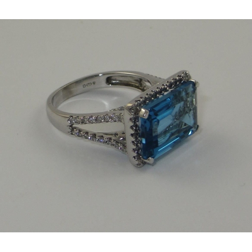 75 - A blue topaz and diamond dress ring