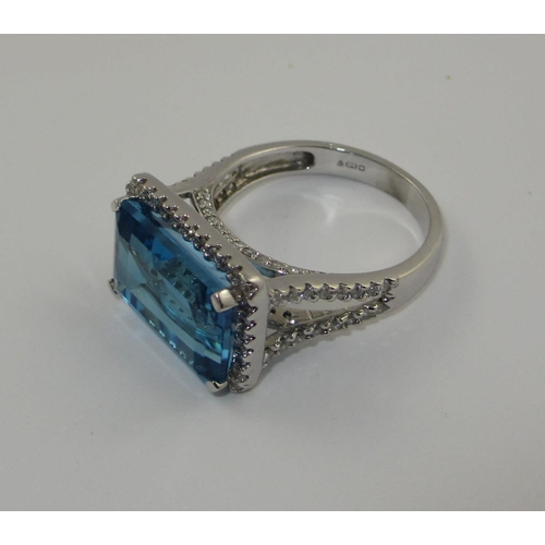 75 - A blue topaz and diamond dress ring